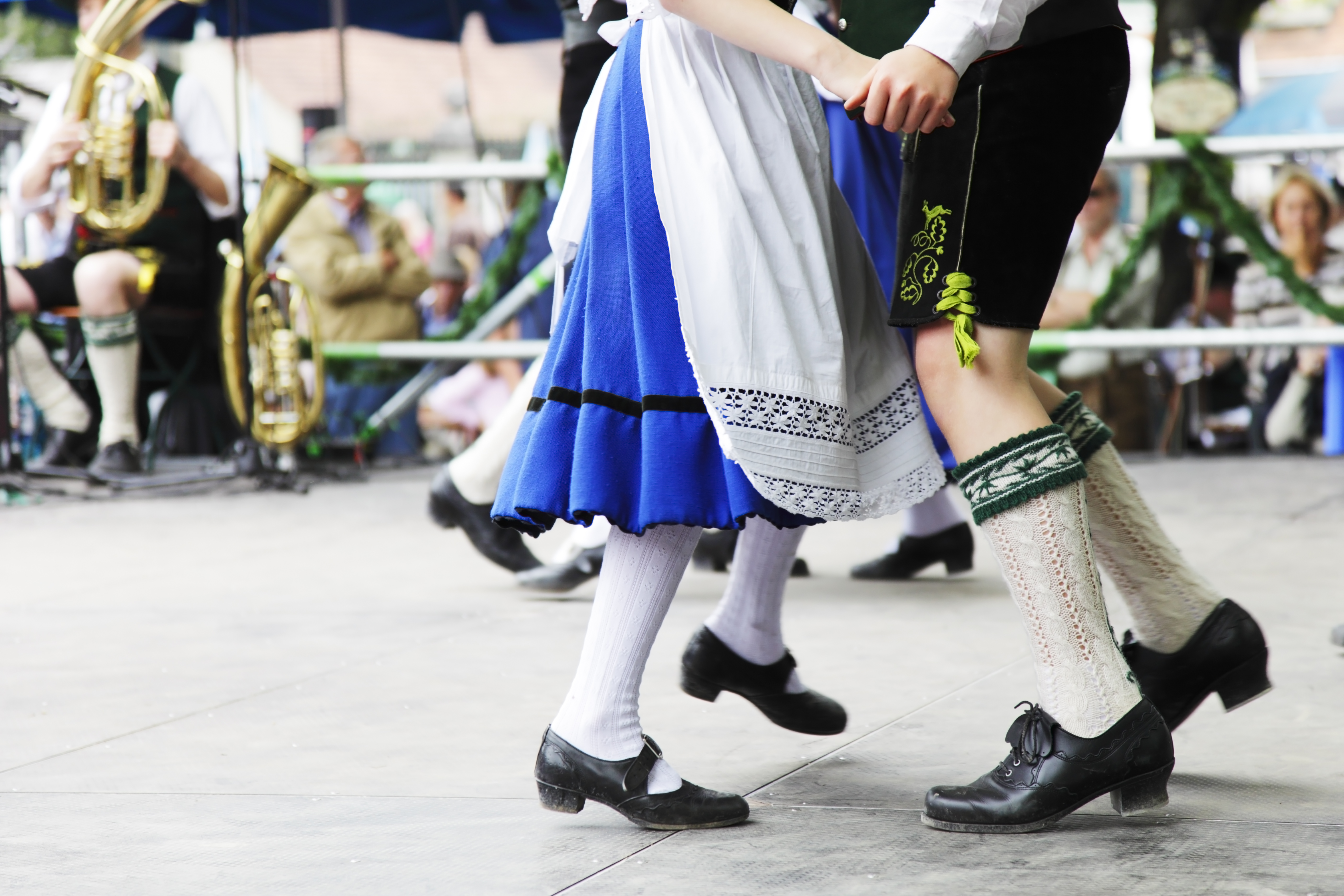 Couple in traditional Bavarian clothing dancing during Wurstfest