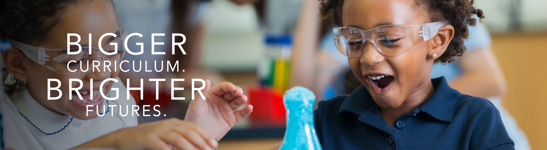 Excited school girls during chemistry experiment