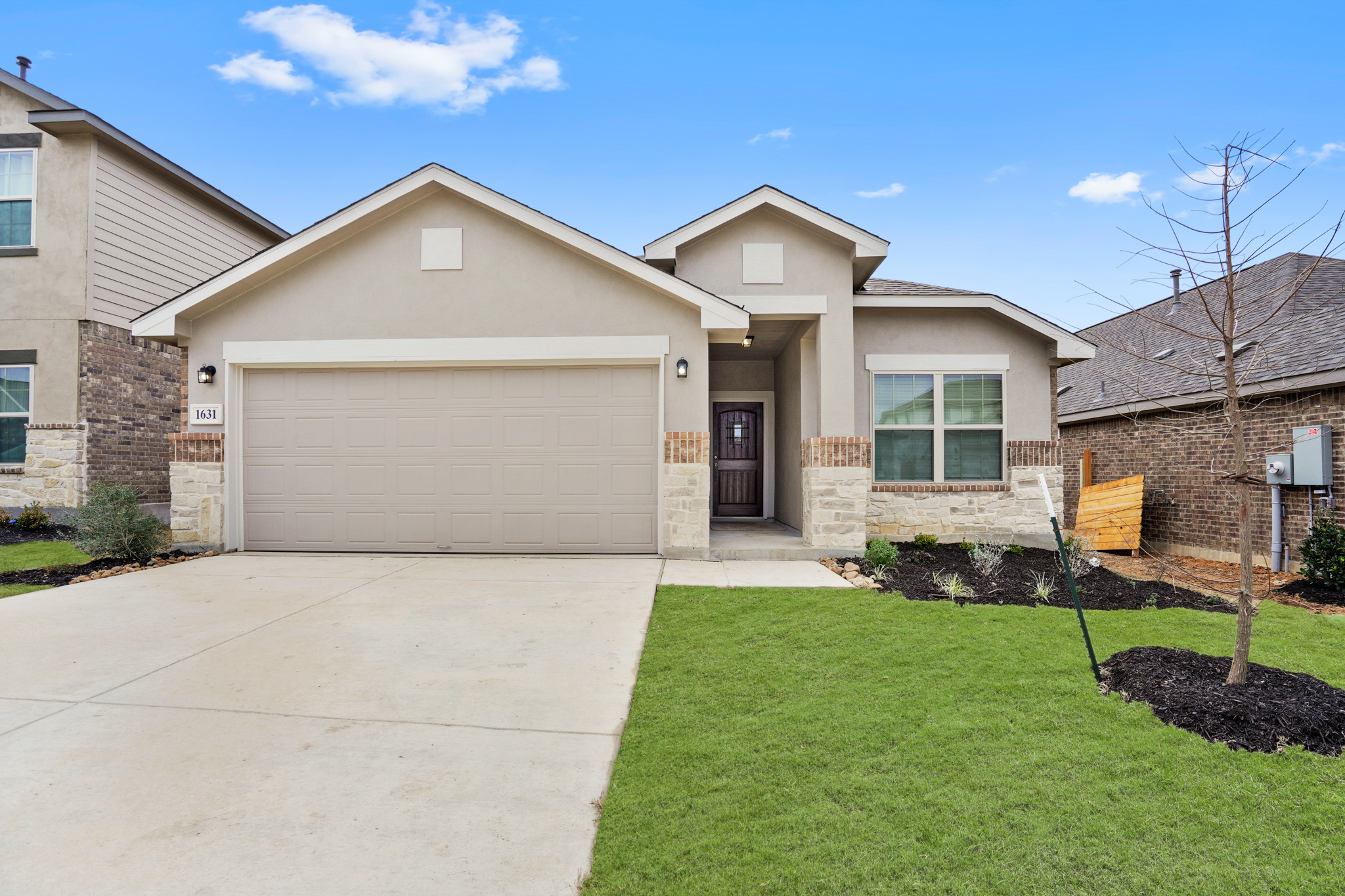 Front view of a new move-in ready home in Meyer Ranch with large garage
