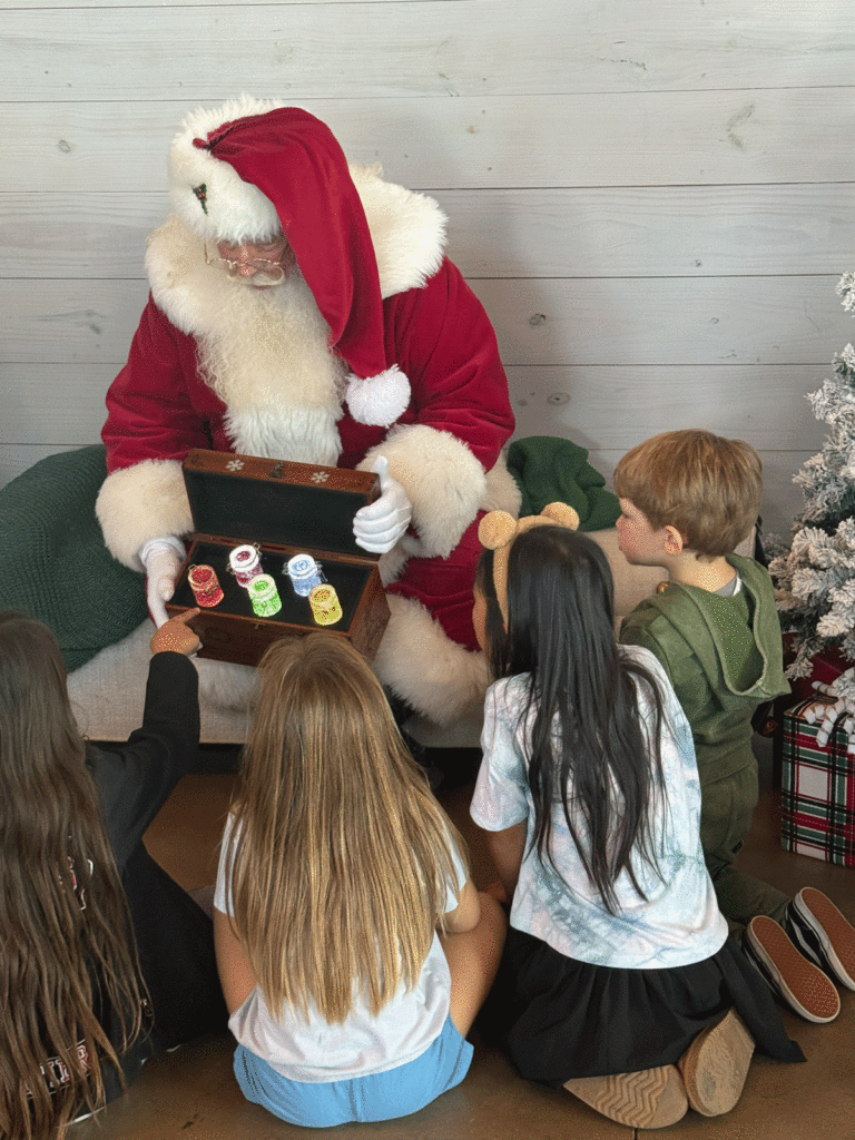 Kids receiving gifts from Santa at Meyer Ranch Deck the Halls event
