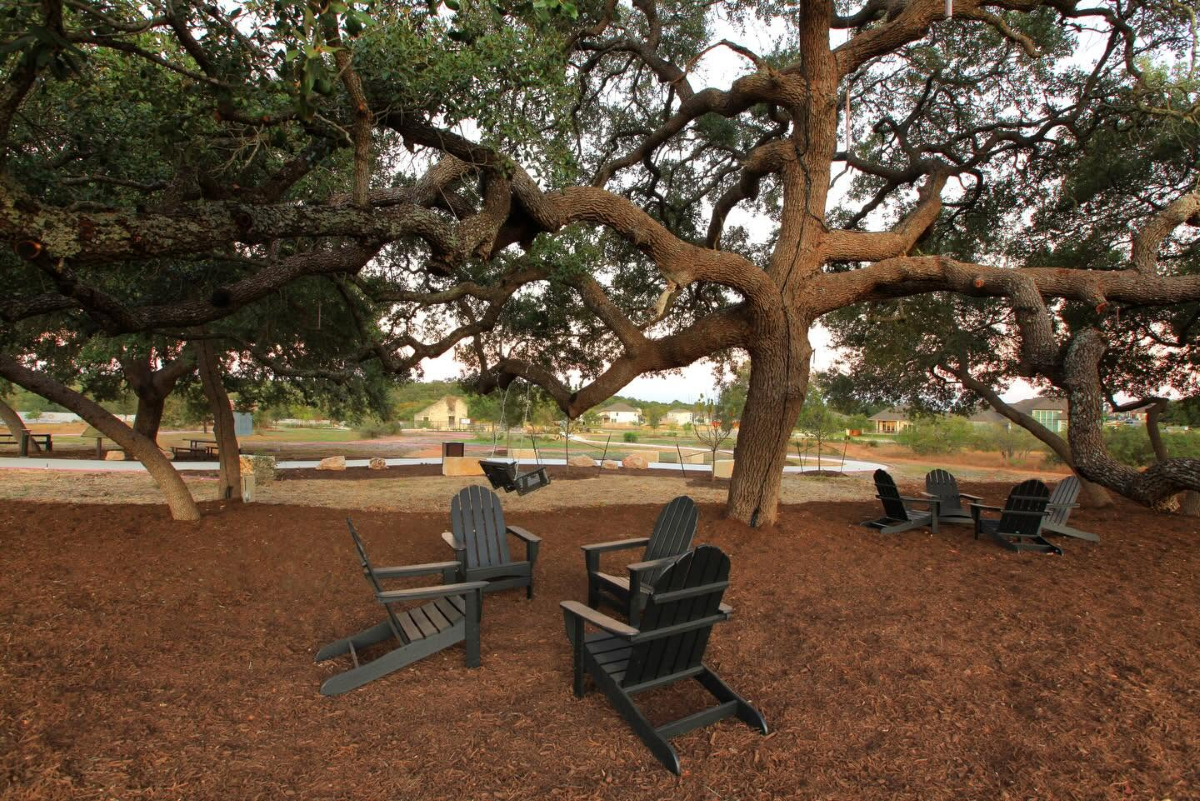 Seating area in Meyer Ranch surrounded by large trees.